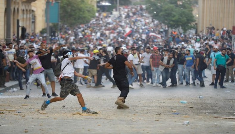 Lebanese protesters, enraged by a deadly explosion blamed on government negligence, clash with security forces for the second evening near an access street to the parliament in central Beirut on August 9, 2020. - AFP photo