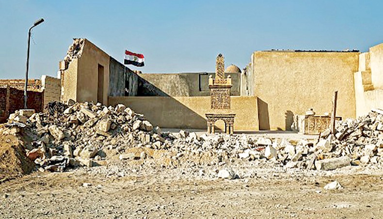 This picture taken on July 22, 2020 shows an Egyptian flag flying behind a grave marker, whose surrounding wall was destroyed, in the historic City of the Dead. — AFP photo
