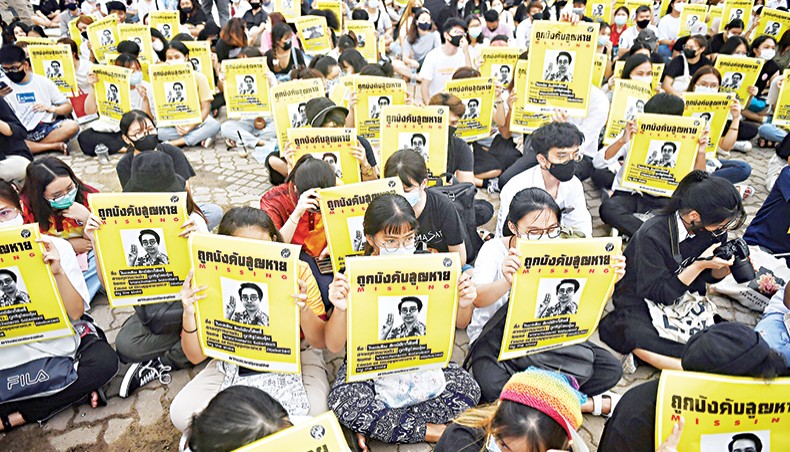 Student protesters hold posters of disappeared rights activist Wanchalearm Satsaksit at an anti-government rally at Thammasat University in Pathum Thani, north of Bangkok on Monday. — AFP photo