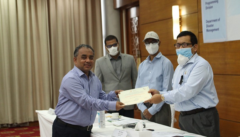 NRP project manager SM Morshed receives certificate from MoDMR secretary Md Mohsin at the concluding session of the training programme in Dhaka on Monday. — Press release