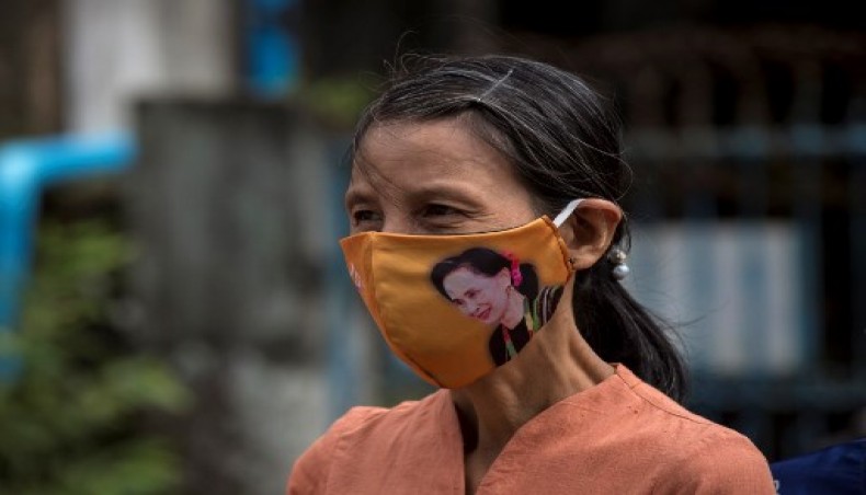 A woman wearing a face mask featuring the image of Myanmar State Counsellor Aung San Suu Kyi, outside the Yangon southern district court where she submitted her application to run as a candidate in the upcoming 2020 general election in Yangon on August 4, 2020.- AFP photo
