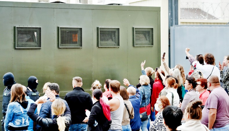 A police van drives out of a detention centre while allegedly transporting people who were jailed to different terms for participating in recent rallies of opposition supporters, who accuse strongman Alexander Lukashenko of falsifying the polls in the presidential election, in Minsk on Wednesday. — AFP photo