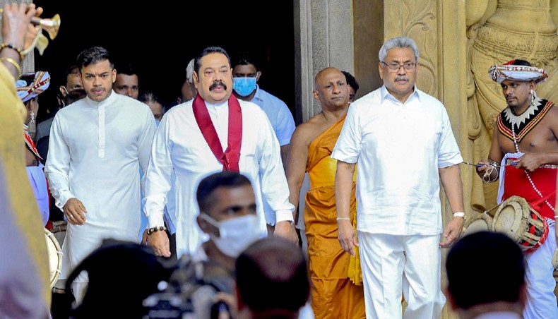 Sri Lanka’s prime minister Mahinda Rajapaksa, second from left, along with president Gotabaya Rajapaksa, second from right, leaves his swearing-in ceremony at the sacred Kelaniya Raja Maha Buddhist temple, outside the capital Colombo on August 9. — Agence France-Presse/Ishara S Kodikara