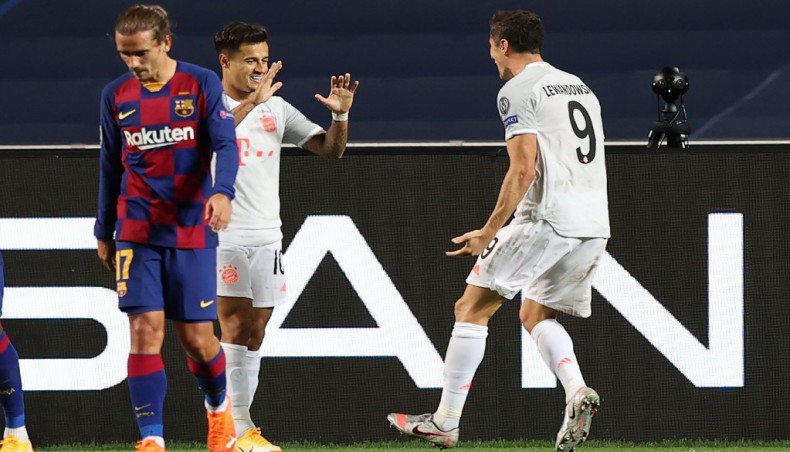 Bayern Munich forward Robert Lewandowski (R) celebrates team-mate Philippe Coutinho after scoring a goal during their UEFA Champions League quarter-final match at the Luz stadium in Lisbon on Friday. — AFP photo