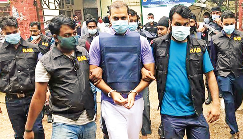 Rapid Action Battalion members take former Teknaf OC Pradeep into their custody for interrogation at Cox’s Bazar on Tuesday over the killing of retired Major Sinha Md Rashed Khan. — Focus Bangla photo