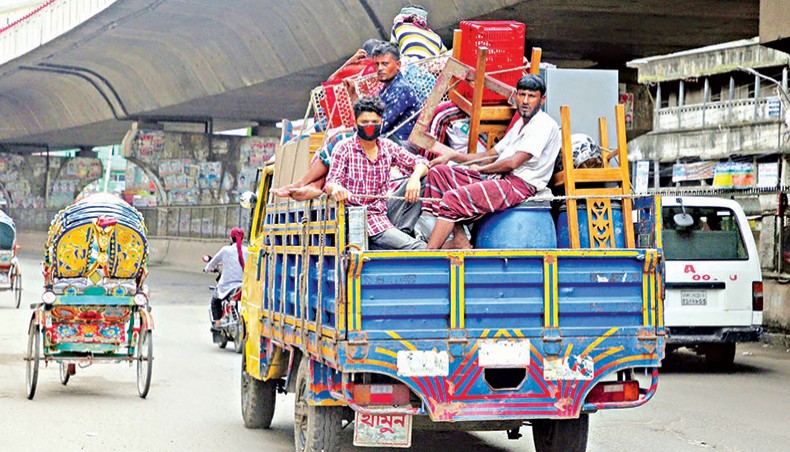 A file photo shows people leaving the capital with their belongings on a truck recently due to income losses amid the coronavirus outbreak in the country. — New Age photo