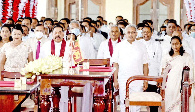Sri Lanka’s president Gotabaya Rajapakse, second from right, and prime minister Mahinda Rajapakse, second from left, along with new cabinet ministers stand for the national anthem during the cabinet swearing-in ceremony at the Buddhist Temple of the Tooth in the ancient hill capital of Kandy on August 12.— Agence France-Presse/Lakruwan Wanniarachchi