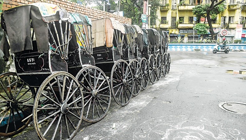 Hand-pulled rickshaws are parked on the roadside during the second day of the two-day state-imposed lockdown as a preventive measure against the surge in COVID-19 coronavirus cases in Kolkata on Friday. — AFP photo