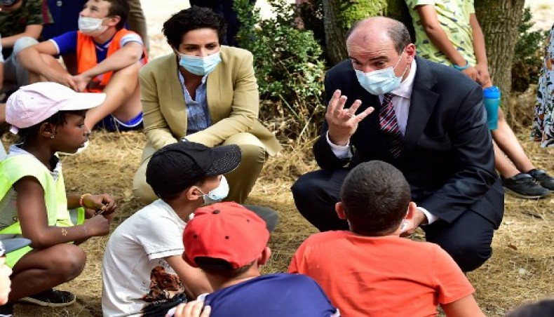 French Prime Minister Jean Castex wearing a protective face mask and accompanied by French Secretary of State for Youth and Engagement, Sarah El Hairy (L) speaks with children during his visit to a learning colony centre on August 18, 2020 in Mondonville, Haute-Garonne, near Toulouse, southern France.- AFP photo