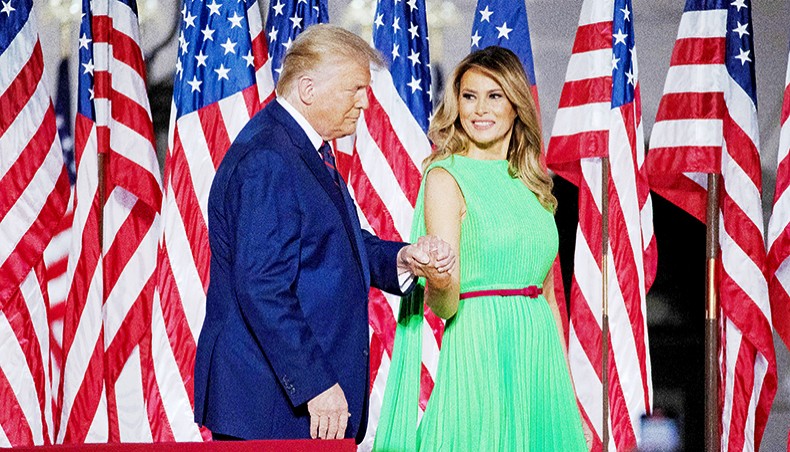 US president Donald Trump leads first lady Melania Trump off the podium as he prepares to deliver his acceptance speech for the Republican presidential nomination on the South Lawn of the White House on August 27, 2020 in Washington, DC. — Chip Somodevilla/Getty Images/AFP