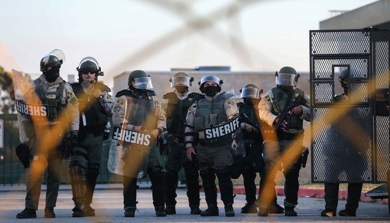 Los Angeles sheriff’s deputies keep watch at the South Los Angeles Sheriffs’ station as protesters demonstrate nearby against the death of Dijon Kizzee, a 29-year-old black man who was shot and killed by police, on September 1, 2020 in Los Angeles, California. — AFP photo
