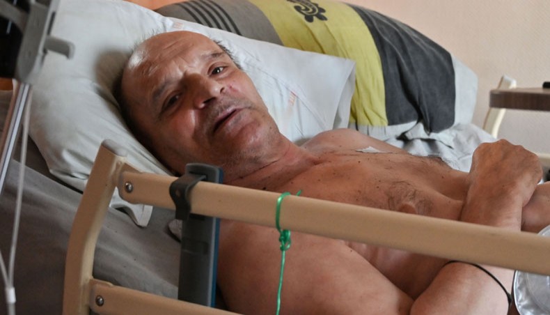 Alain Cocq, suffering from an orphan disease of the blood, rests on his medical bed in his flat in Dijon, northeastern France on August 12. — AFP Photo