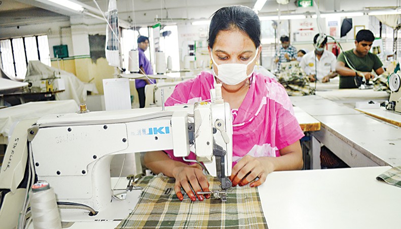 A file photo shows workers wearing masks sewing clothes at a factory on the outskirts of Dhaka. The country’s apparel export to the United States in January-July this year fell by 18.54 per cent due to the global economic slowdown witnessed in the wake of the coronavirus pandemic. — New Age photo