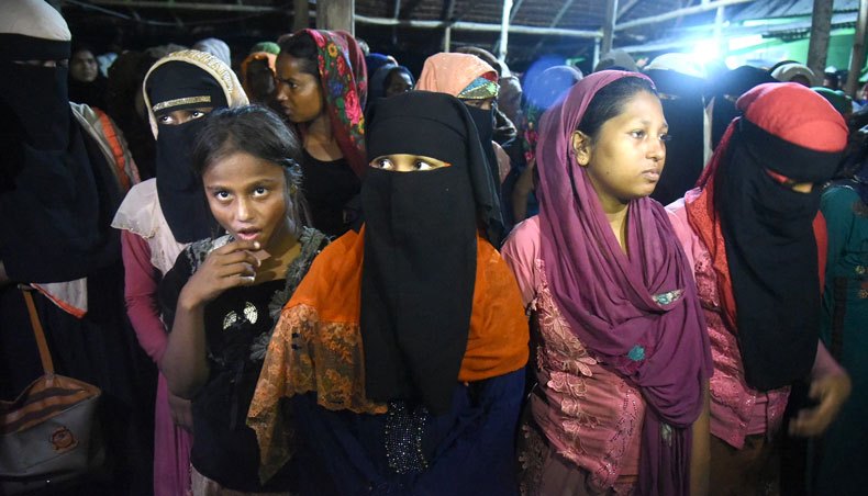 Rohingya migrants look on following their arrival by boat in Lhokseumawe, Aceh on September 7, 2020. — AFP photo