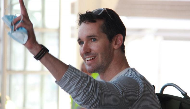 This handout photograph taken and released on September 8, 2020 by ABC News shows Australian broadcasting corporation journalist Bill Birtles waving as he arrives in Sydney after leaving China over arrest fears, amid worsening diplomatic relations between the two countries. — AFP photo