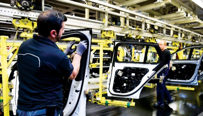 A file photo shows workers working at a car factory in Germany. Investor confidence in Germany unexpectedly soared to a 20-year high in September. — AFP photo