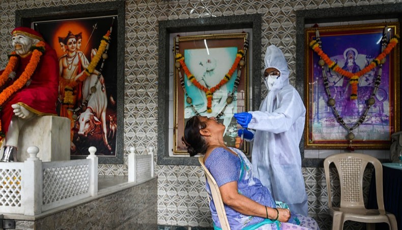 A health worker collects a swab sample from a resident for the COVID-19 coronavirus test in a temple in Mumbai on September 15, 2020. -- AFP photo