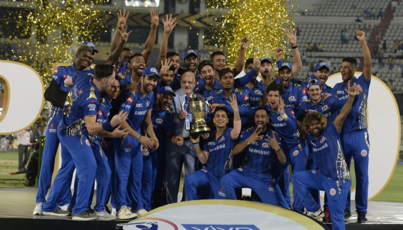 This file photo taken on May 13, 2019 shows Mumbai Indians players celebrating with the trophy after Chennai Super Kings in Indian Premier League final at the Rajiv Gandhi International Cricket Stadium in Hyderabad. — AFP photo