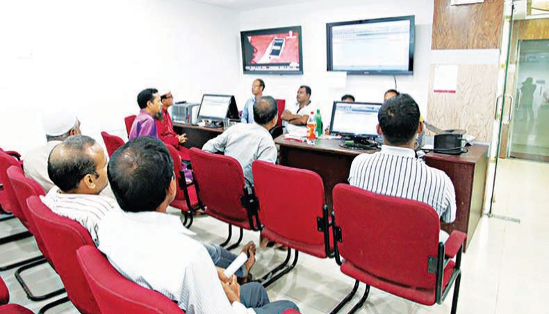 A file photo shows investors monitoring the stock price movement on computer screens at a brokerage house in capital Dhaka. Dhaka stocks gained marginally for the second day on Wednesday as investors, encouraged by the recent rally and upbeat economic data, kept buying shares.— New Age photo