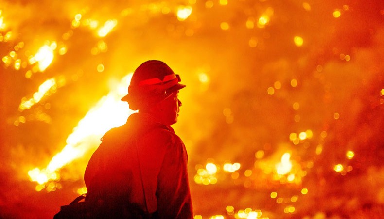 A firefighter watches the Bobcat Fire burning on hillsides near Monrovia Canyon Park in Monrovia, California on Tuesday. A major fire that has been raging outside Los Angeles for more than a week threatened to engulf a historic observatory and billion-dollar broadcast towers on Tuesday as firefighters struggled to contain the flames. — AFP photo