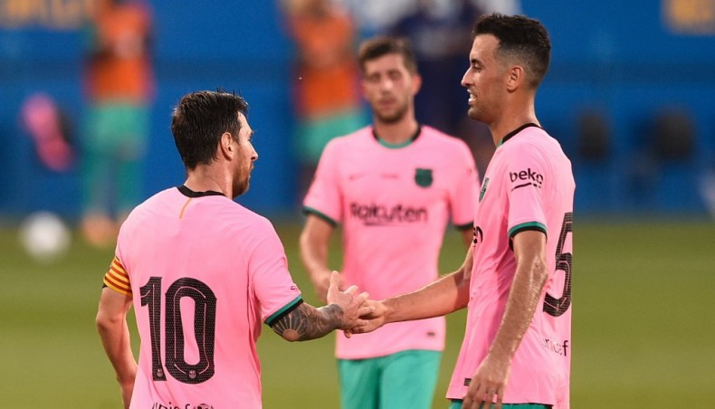 Barcelona forward Lionel Messi (L) celebrates with team-mate Sergio Busquets after scoring against Girona during a friendly match at the Johan Cruyff Stadium on Wednesday. — AFP photo