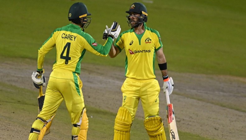 Australia's Glenn Maxwell congratulates team-mate Alex Carey after he scored a century during their third and final one-day international match against England at Old Trafford in Manchester on Wednesday. — AFP photo