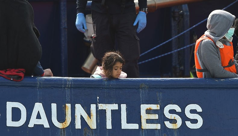 A girl stands on board the DHB Dauntless tug boat as a group of migrants are brought to shore by the UK Border Force after illegally crossing the English Channel from France on a dinghy on September 11, 2020, in the marina at Dover, on the south coast of England. — AFP photo