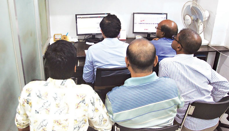 A file photo shows investors monitoring movement of share prices at a brokerage house in Dhaka. No listed company has held extra ordinary meetings within one month of shutting down production since the inception of BSEC rules in 2010 which make it mandatory for the companies to hold the meeting within the stipulated time informing shareholders about the reasons for closure. — New Age photo