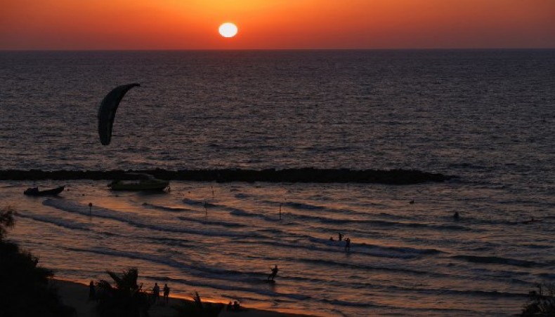 A person practices kite surfing as the sun goes down into the Mediterranean sea in the Israeli coastal city of Netanya, on September 14, 2020.- AFP photo