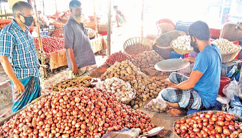 A file photo shows a vendor sells different commodities including onions at a kitchen market at Matuail in the capital on Friday. The price of onion remained high despite decreasing slightly on the city markets on Sunday amid news of import of the item from different destinations.— Focusbangla photo