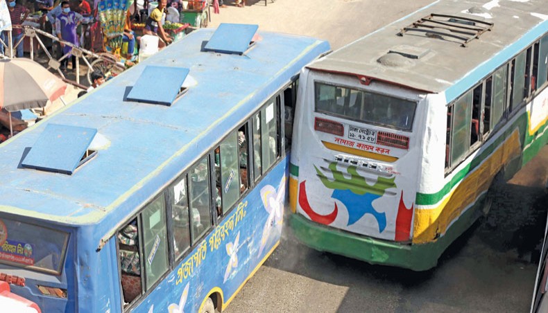 Two buses abrade each other while engaged in a race in front of Hazrat Shahjalal International Airport in Dhaka on Sunday. — Sony Ramany