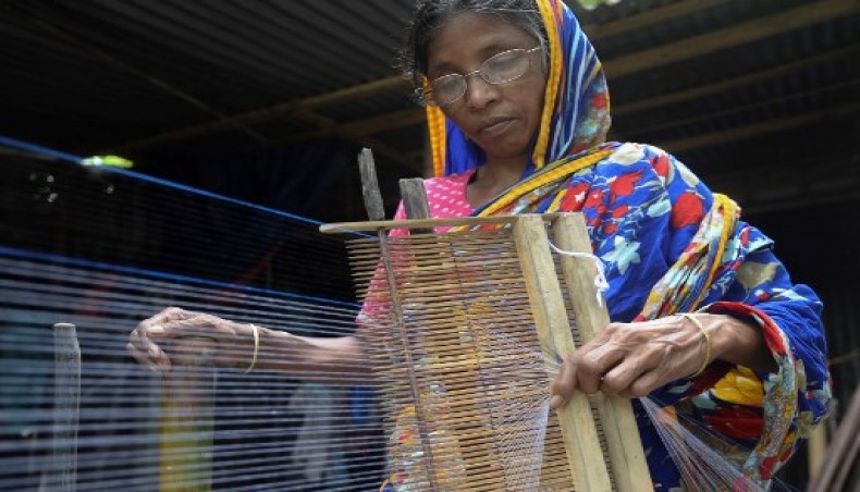 In this picture taken on September 15, 2020, a weaver prepares threads to make fabric with a handloom in Ruhitpur on the outskirts of Dhaka. In small tin sheds in a rural town just outside Bangladesh's capital Dhaka,- AFP photo