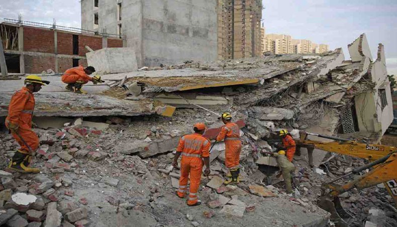 Rescuers search survivors at the site of a collapsed building. — AP/ UNB