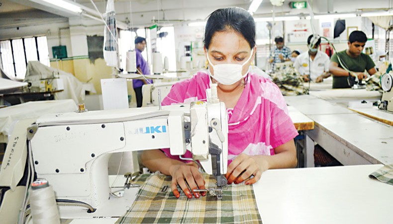 A file photo shows readymade garment workers sewing clothes at a factory on the outskirts of Dhaka. — New Age photo