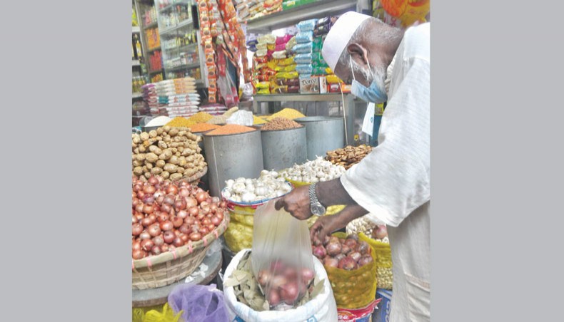 A man buys onions at a shop at a kitchen market at Shantinagar in the capital on Friday. — Focusbangla photo