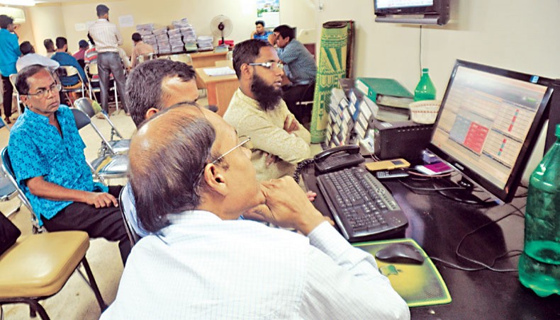 A file photo shows people monitoring share price movements on a computer screen at the Dhaka Stock Exchange in the capital. The Bangladesh Securities and Exchange Commission may not allow tenure extension to any more mutual funds without the permission of unitholders. — New Age photo