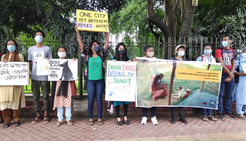 Animal rights activists form human chain in front of Dhaka Club in the capital protesting at Dhaka South City Corporation’s move of dog relocation on Saturday. — New Age photo