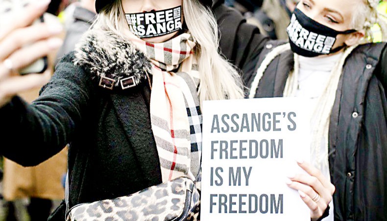 Protestors wear #FREEASSANGE face masks outside Belmarsh prison prior to Julian Assange’s extradition hearing on February 24, 2020 in London. — Getty Images/Leon Neal