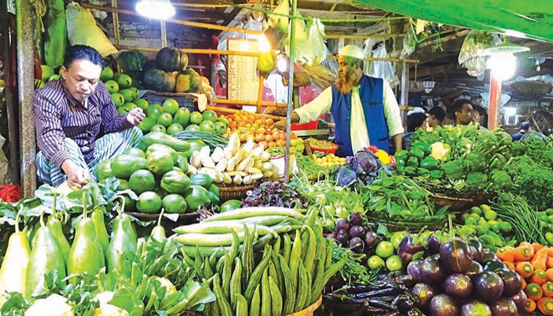 A vendor arranges vegetables at a kitchen market at Kaptan Bazar in the capital on Friday. — New Age photo