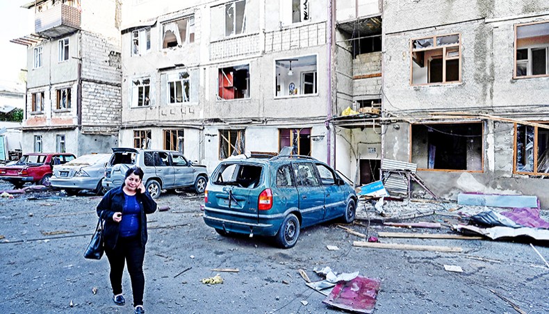A woman cries walking in front of an apartment building that was supposedly damaged by recent shelling in the breakaway Nagorno-Karabakh region’s main city of Stepanakert on Saturday, during the on-going fighting between Armenia and Azerbaijan over the disputed region. — AFP photo