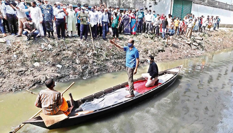 Dhaka north city mayor Md Atiqul Islam visits Godakhali Canal on a boat at Mirpur-1 in Dhaka on Wednesday to inspect a cleaning drive. — New Age photo