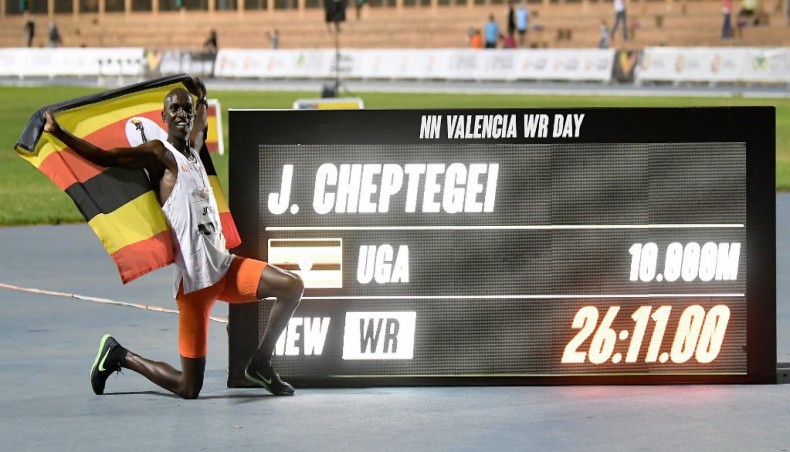 Ugandan athlete Joshua Cheptegei waves the Uganda national flag as he celebrates after breaking the 10,000m track world record during the NN Valencia World Record Day at the Turia stadium in Valencia on Wednesday. — AFP photo