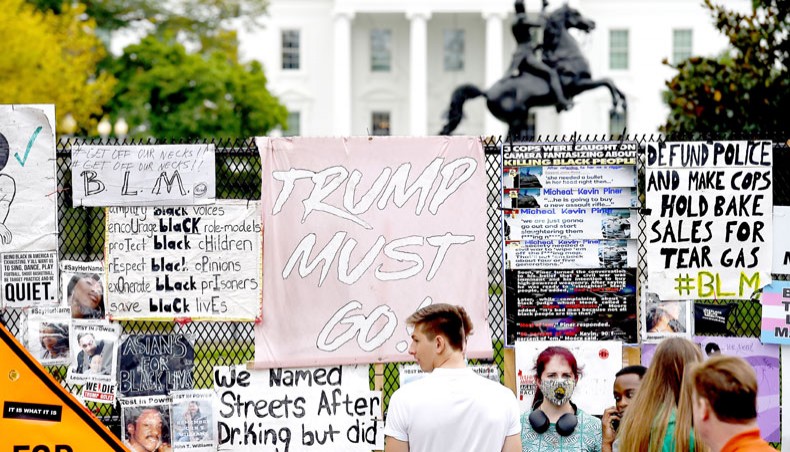 People stand at Black Lives Matter Plaza in Washington, DC, on October 10, 2020, ahead of a speech by US president Donald Trump at the White House. — Agence France-Presse/Olivier Douliery