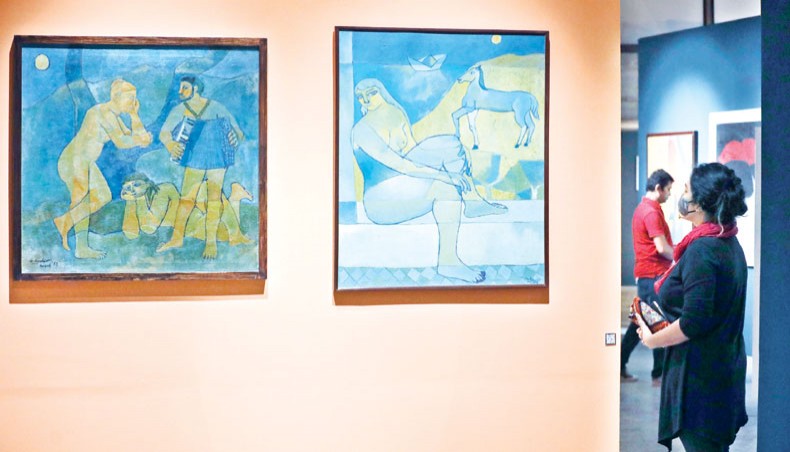 A visitor looks at Murtaja Baseer’s early oil-on-canvas works displayed at an on-going exhibition under way at Bengal Shilpalay in Dhanmondi on Monday. — Sourav Lasker