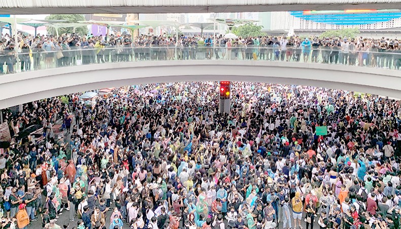 Pro-democracy protesters gather on a major road intersection for an anti-government rally in Bangkok on Friday, after Thailand issued an emergency decree. — AFP photo