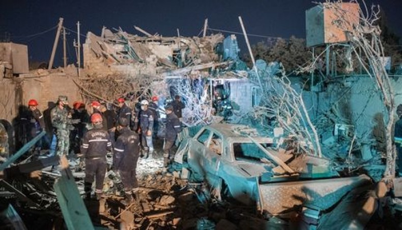 Rescue teams work at a site hit by a missile strike during fighting over the breakaway region of Nagorno-Karabakh, in the city of Ganja, Azerbaijan early on October 17, 2020. — AFP photo