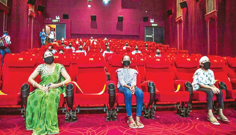 People invited as ‘Covid-19 warriors’ and their families to a special screening watch Bollywood movie ‘Tanhaji’ in a cinema in New Delhi on October 15, 2020, with some states still keeping theatres closed amid the Covid-19 coronavirus pandemic. — AFP photo