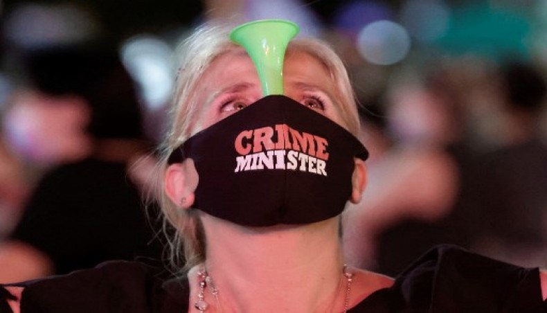 An Israeli protester, wearing a protective mask due to the COVID-19 pandemic, blows a plastic horn during a demonstration against Prime Minister Benjamin Netanyahu in the coastal city of Tel Aviv, on October 17, 2020.- AFP photo