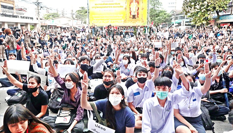 Pro-democracy protesters give the three-finger salute during an anti-government rally at the MRT ministry of public health in Bangkok on Monday, as they continue to defy an emergency decree banning gatherings. — AFP photo