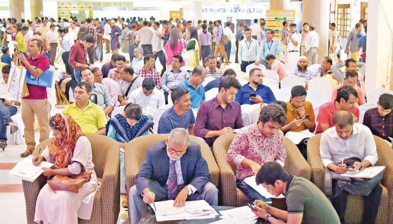 A file photo shows people busy filling in tax return forms at the central venue of the income tax fair at Officers’ Club Dhaka on November 17, 2019. Revenue collection by the National Board of Revenue gained further pace in the first quarter of the current fiscal year 2020 2021, riding on significant growth in September after the adverse impacts of the COVID-19 outbreak on the economy. — New Age photo